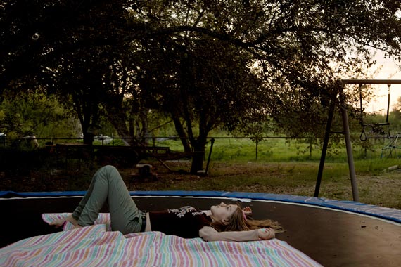 young woman laying on a trampoline