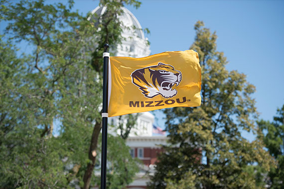 Mizzou Tiger logo flag in front of Jesse Hall