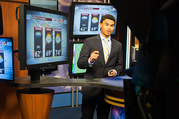 Student doing weather at KOMU TV station