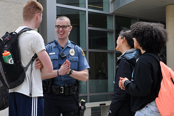 MU police officer chatting with students outside MU Student Center