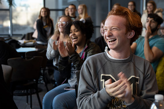 Students smiling and applauding