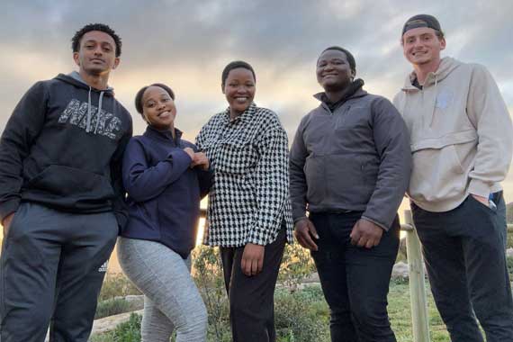 MU students Nez Redi (left) and Michael Moriarty (right) visit with students from the University of the Western Cape (UWC)