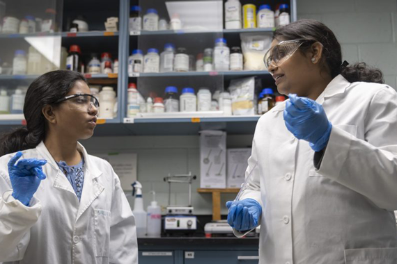 Mizzou graduate student Karishma Sri Ravichandran (left) speaks with Kiruba Krishnaswamy while working in the lab at the University of Missouri.