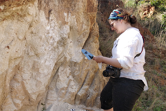 Woman collects samples from mountain side