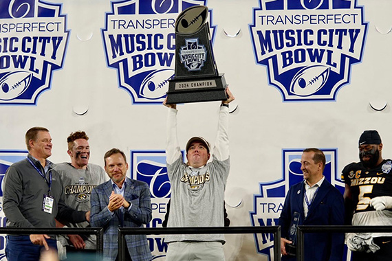 Man holds trophy