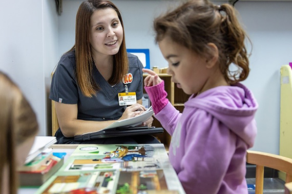 Mizzou student works with child in lab