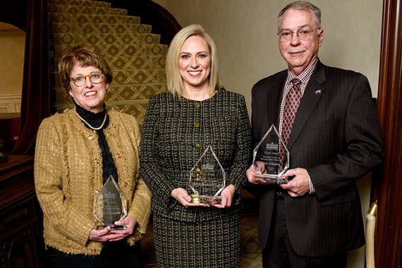 Three people with awards