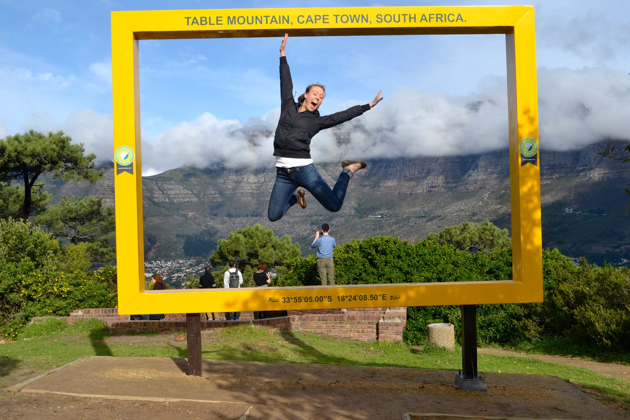 Student leaping in front of large frame