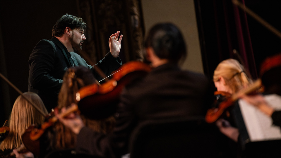 Conductor leading an orchestra