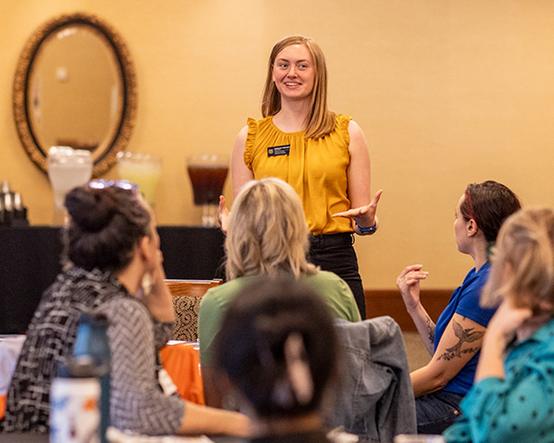 Student speaking to a group of people