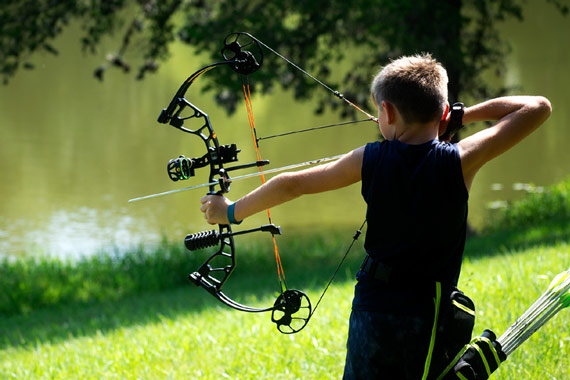 A boy shooting a bow and arrow