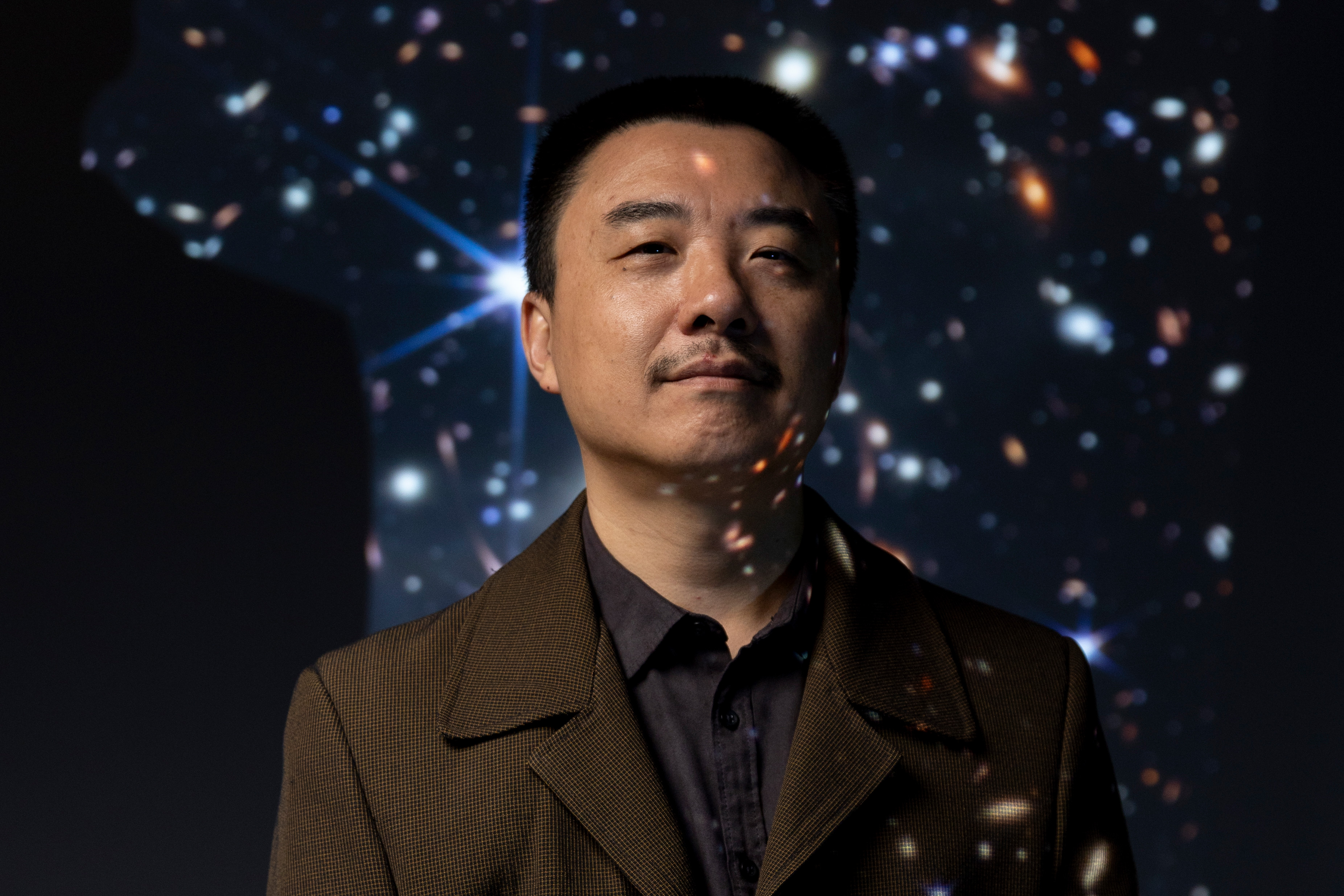 Person standing in front of a starry sky