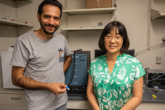 Two people standing in a lab