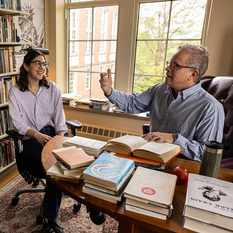 A Mizzou faculty member talking to a student in his office
