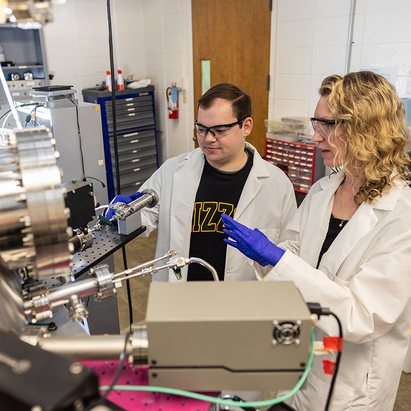A Mizzou student and professor working in a high tech lab
