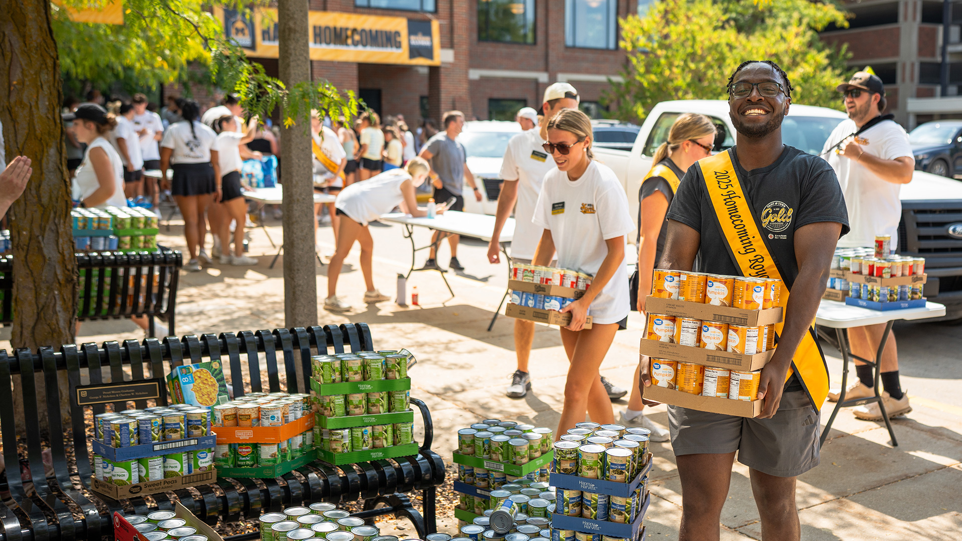 MIzzou homecoming court collecting canned goods during a food drive