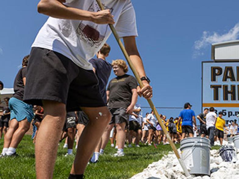 Students painting the Rock M at the Memorial Stadium